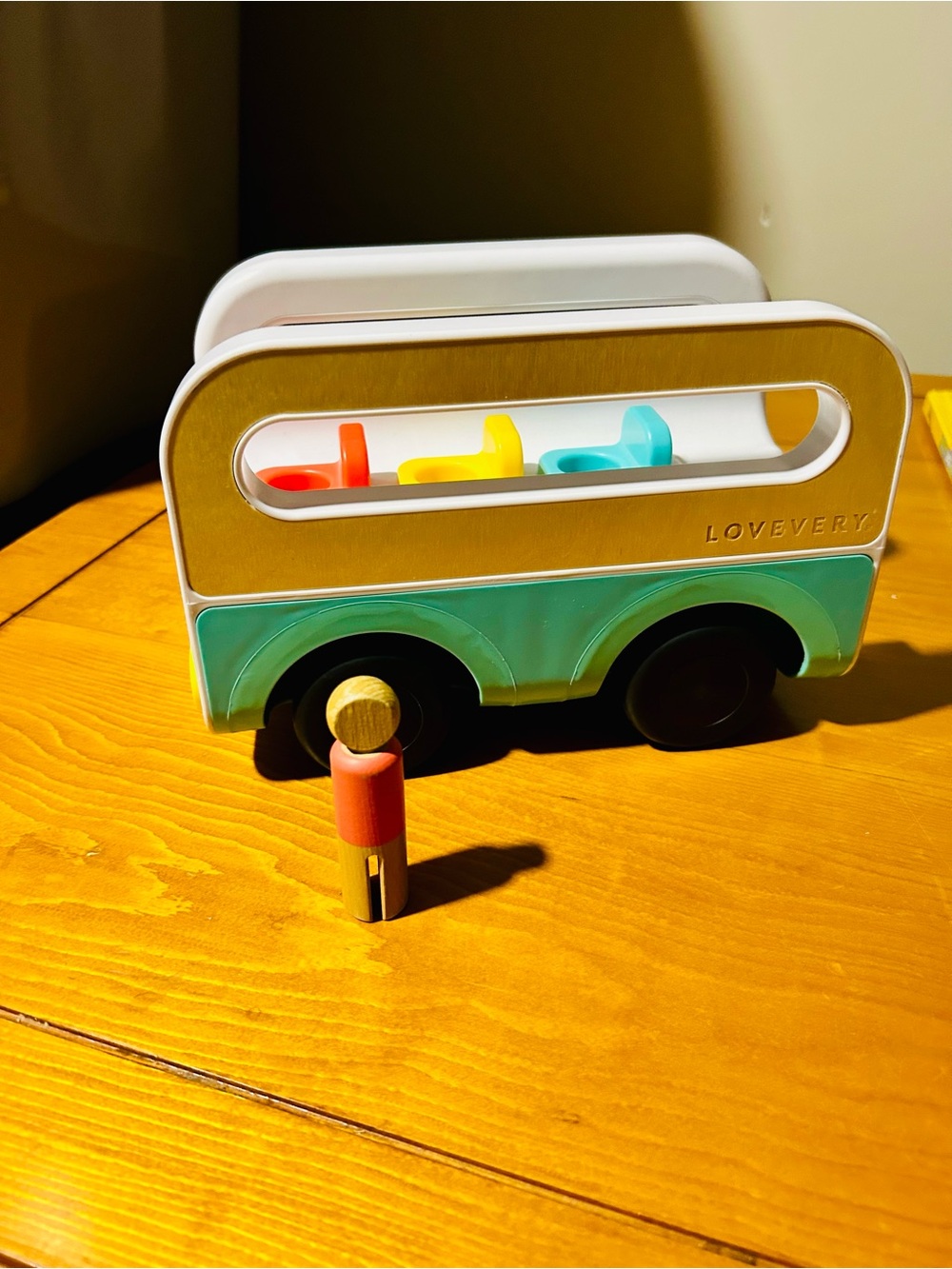 Lovevery Teal and White Wooden Toy Bus with Colorful Pegs